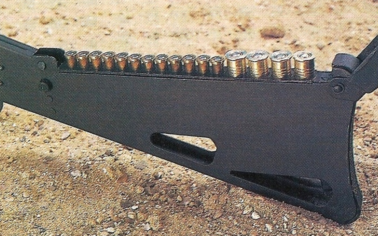 Le busc de la crosse comporte un appui-joue articulé qui fait office de couvercle à la réserve de munitions.